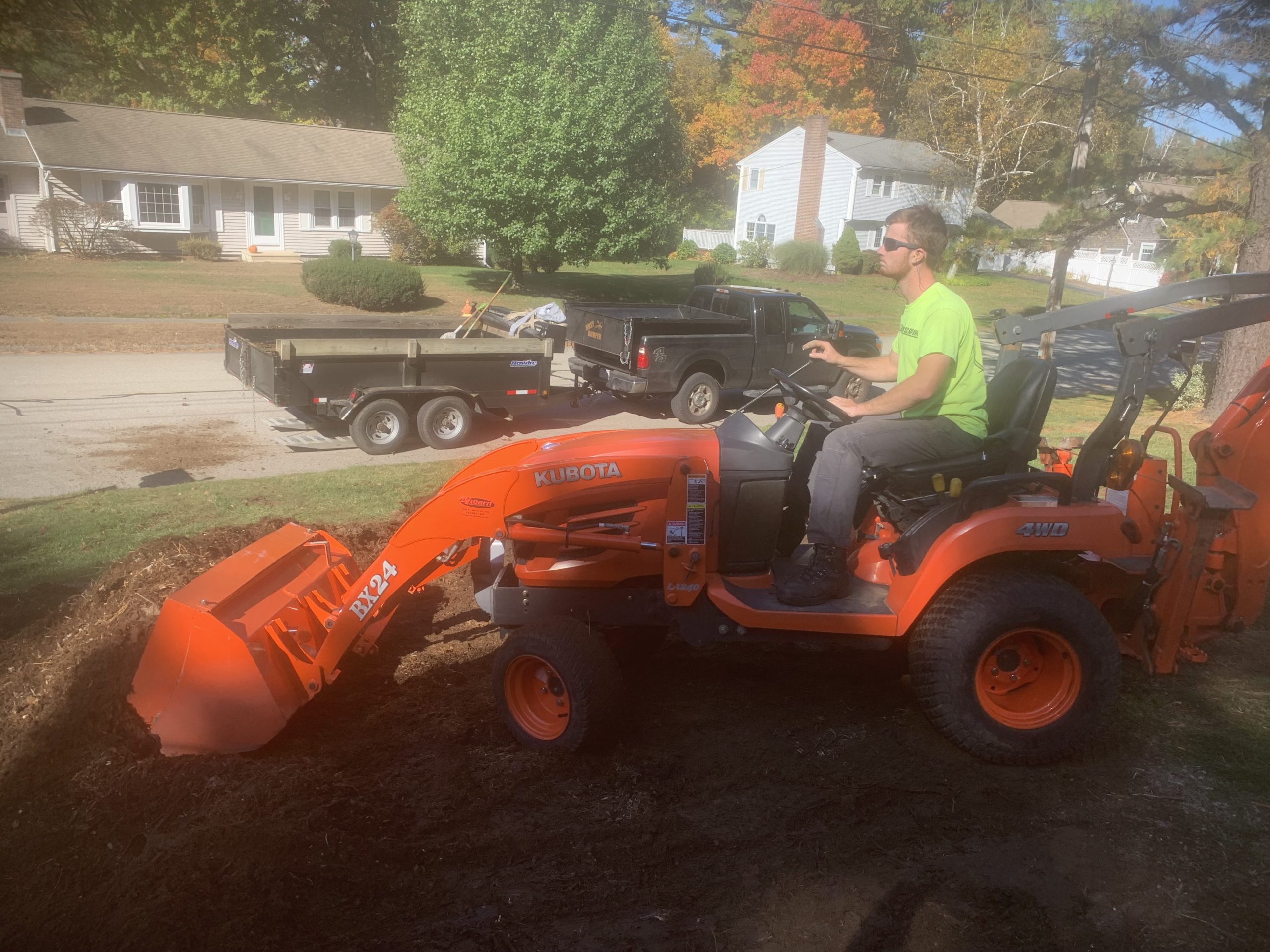 alex pushing dirt with a kubota tractor